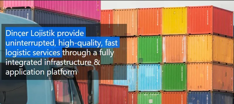 Stacks of colorful shipping containers in a logistics yard, with a truck cab in the foreground